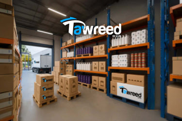 Warehouse interior with shelves and boxes, featuring Tawreed logo.
